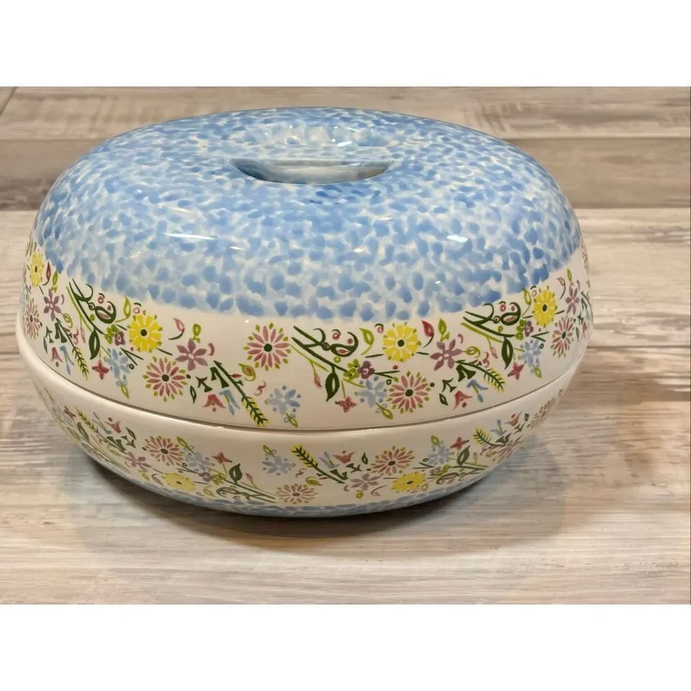 Temp-tations Ovenware by Tara Blue oval covered casserole dish with a metal stan